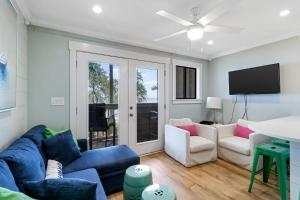 a living room with a blue couch and chairs at Oceanfront Sunrises on Mitchelville Beach in Hilton Head Island
