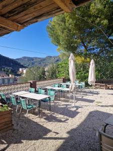 a group of tables and chairs with umbrellas at Glamping Montanejos in Montanejos