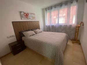 a bedroom with a large bed with a window at Estación 1 in Murcia