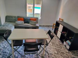 a living room with a table and a couch at Calle platano37 in Valencia
