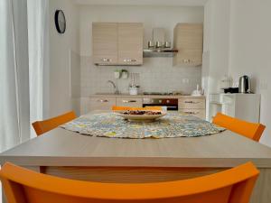 a kitchen with a table with a bowl of fruit on it at Lemon House in Taormina