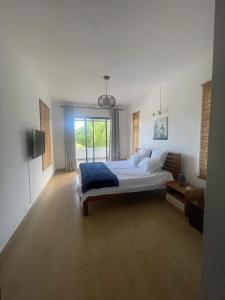a bedroom with a bed and a large window at Villa Coco in Trou aux Biches +25 photos
