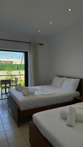 Postel nebo postele na pokoji v ubytování Enelia Apartments