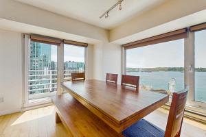 a dining room with a wooden table and large windows at Newmark Tower in Seattle