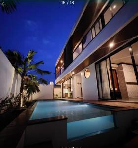a villa with a swimming pool at night at Canggu Velvet Oasis - Private Villa 3Bedroom in Dalung