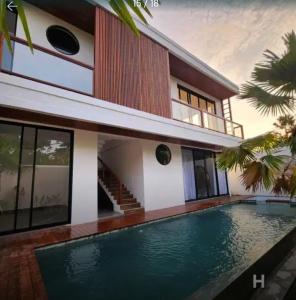 a house with a swimming pool in front of it at Canggu Velvet Oasis - Private Villa 3Bedroom in Dalung