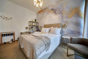 a bedroom with a large bed with a mural on the wall at Rooms Indigo Bundek in Zagreb
