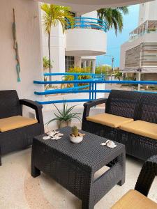 a patio with a table and chairs and a pool at Quiet apartment one block from the beach in Playa Bello Horizonte +5 photos