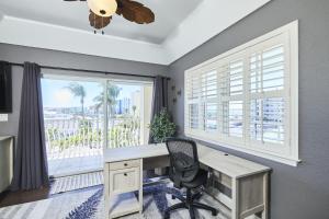a home office with a desk and a window at Mojito Haze beach retreat in St Pete Beach