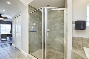 a glass shower in a bathroom with at Mojito Haze beach retreat in St Pete Beach +55 photos