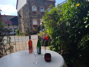 a table with two bottles of wine and two glasses at Am Weinberg in Bernkastel-Kues
