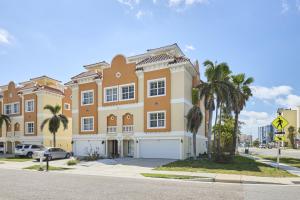 a large building with palm trees in front of it at Mojito Haze beach retreat in St Pete Beach