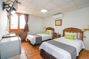 Postel nebo postele na pokoji v ubytování Hotel El Marqués