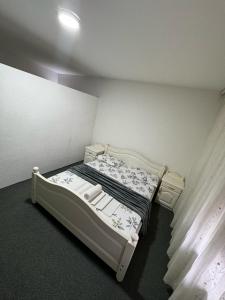a small bed in a small room with a bed frame at Motel Albatros in Kosovo Polje