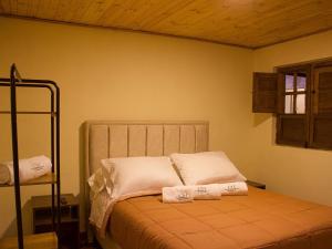 a bedroom with a bed with two towels on it at Casa Hernandez in La Calera +27 photos