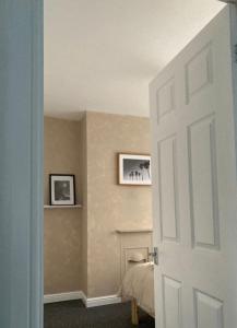 a room with a bedroom with a bed and a fireplace at Base in the Black Country, 4 Beds & Large Drive in Brownhills