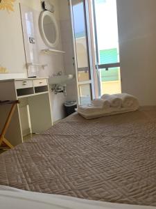 Postel nebo postele na pokoji v ubytování Smile Beach Hotel Nuova Gestione