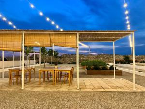 a pavilion with a table and chairs on a patio at Masseria Voluzzi in Copertino