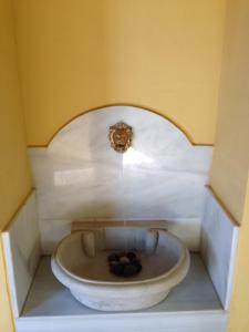 a bathroom with a sink with balls in it at Casa Palacio de Guadix in Guadix