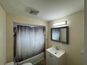 ナイアガラフォールズにあるGetaway Home at Niagara!の洗面台、トイレ、鏡のあるバスルーム