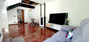 a living room with a couch and a flat screen tv at La luz de Llanes in El Cueto