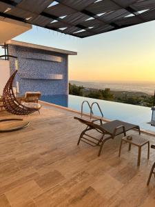 a patio with chairs and tables on a roof at Kalkan da Vaıllant Villa in Kaş