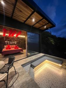 a patio with a table and a bench on a deck at Arrayán Glamping Villa 2 in San Gil