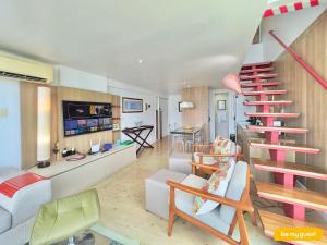 a living room with a staircase and a couch at Loft Praia - Meireles in Fortaleza