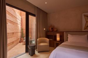 a bedroom with a bed and a chair and a window at Casa Cunda in Oaxaca City +72 photos