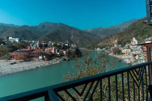 a view of a river from a balcony at Joey's By The Ganges in Rishīkesh
