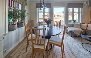 a dining room and living room with a table and chairs at 3 Bedroom Stunning Home In Holmsbu in Holmsbu