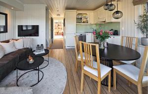 a kitchen and living room with a table and a couch at 3 Bedroom Stunning Home In Holmsbu in Holmsbu