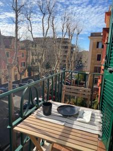 a table on a balcony with a view of a city at Docking House in Lido di Ostia