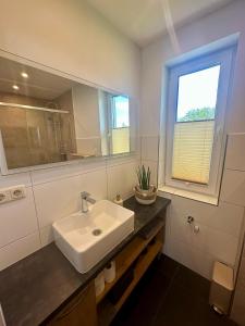 a bathroom with a sink and a mirror and a window at OdpocznieszTU in Brzozowa +31 photos