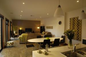 a living room with a couch and a table at Abode Bendigo Apartments in Bendigo