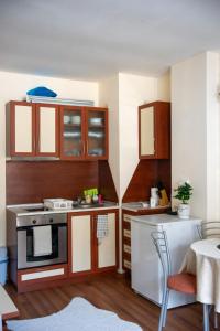 a small kitchen with a stove and a table at Sunny studio in Pamporovo in Pamporovo