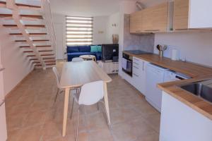 a kitchen with a table and chairs in a room at Alíseos in Costa de Antigua +21 photos