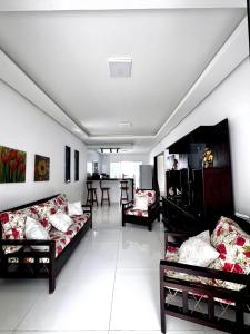 a living room with two couches and a table at Casa na praia de Tamandaré in Tamandaré