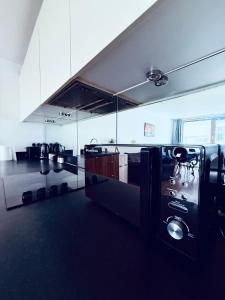 a large kitchen with a large glass wall at Clara Place in Barking - One Bedroom in Barking