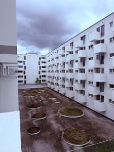 a large white apartment building with many windows at Clara Place in Barking - One Bedroom in Barking +16 photos