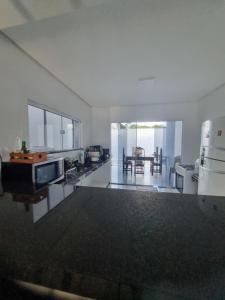a large living room with a kitchen and a table at Casa na praia de Tamandaré in Tamandaré +3 photos