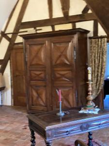 a wooden cabinet with a candle on top of a table at Cambraye in Marcilly-sur-Vienne +21 photos