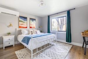 a bedroom with a white bed and a window at Scenic Mountain Getaway by the Park in Flagstaff