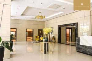 a lobby with a table with flowers on it at Mactan Newtown 2 Bedrooms Suite in Lapu Lapu City +14 photos