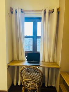 a laptop sitting on a desk in front of a window at Yogi's Heritage in Patan - Heritage Family Studio in Pātan
