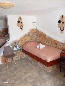 a bedroom with a bed in a stone wall at Lucas B Panorama in Sikinos