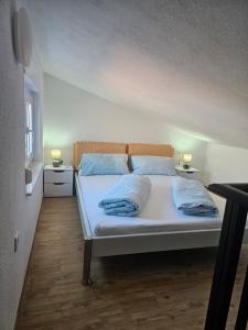a bed in a room with two pillows on it at Villa BOTIĆ in Trogir +120 photos