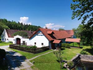 a large white house with a red roof at Chaloupka Větrník na samotě u lesa in Římov