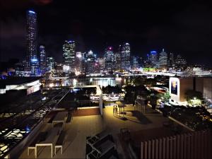a city at night with many lights and buildings at Fleet Lane Apartments in Brisbane