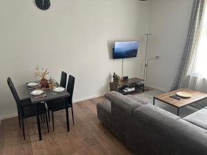 a living room with a couch and a table and a television at gemütliche Wohnung in Witten in Witten